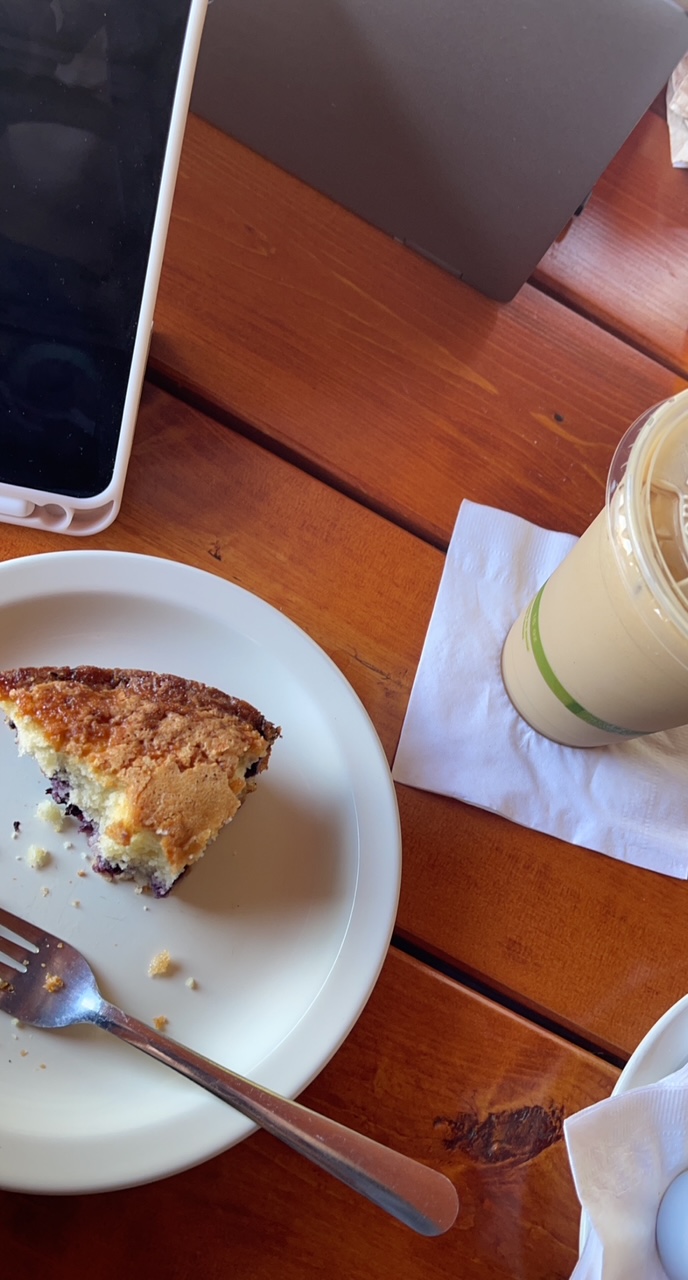 Coffee and breakfast pastry on a cafe table
