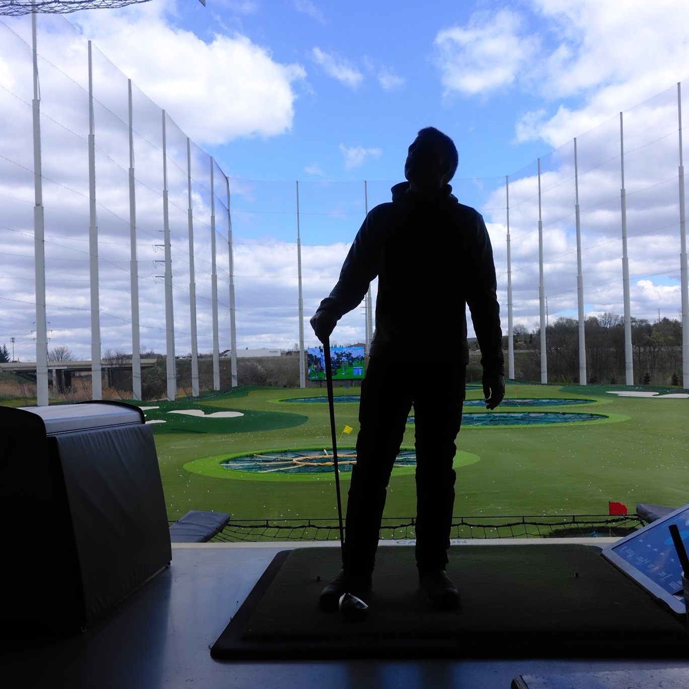 Silhouette of Kait's husband with a golf club at Top Golf 