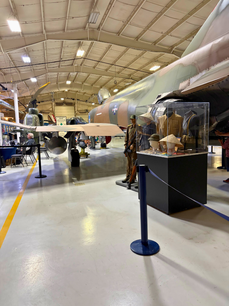 Airplane, helicopter, and uniforms displayed at the Michigan Flight Museum