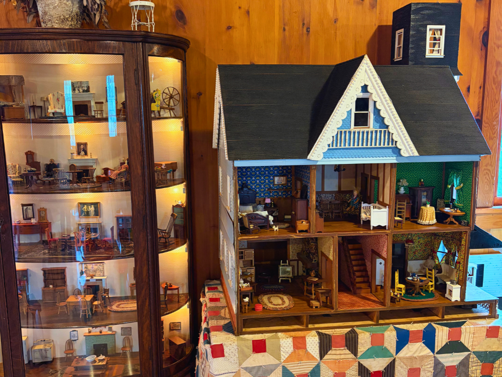 Vintage dollhouse and dollhouse accessories displayed in Macon Mill