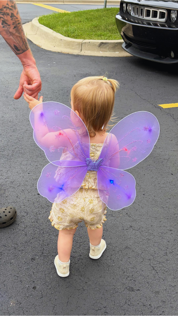 Kait's daughter with the purple, light up butterfly wings on